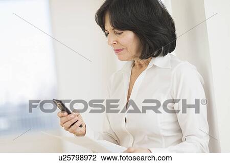 Portrait of senior businesswoman texting on mobile View Large Photo Image Stock Image - Portrait of senior businesswoman texting on mobile. Fotosearch