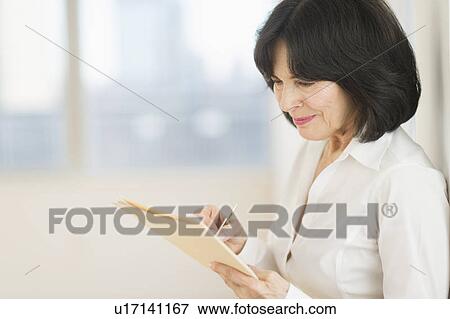 Portrait of senior businesswoman writing View Large Photo Image Stock Photo - Portrait of senior businesswoman writing. Fotosearch