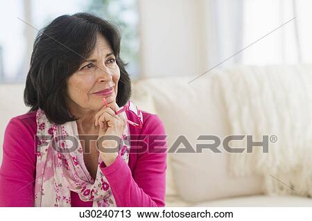 Stock Image - Portrait of senior woman contemplating. Fotosearch
