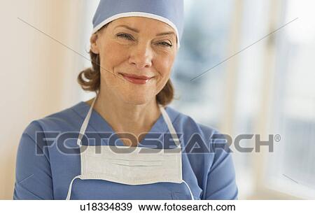 Stock Photo - Portrait of smiling female surgeon. Fotosearch