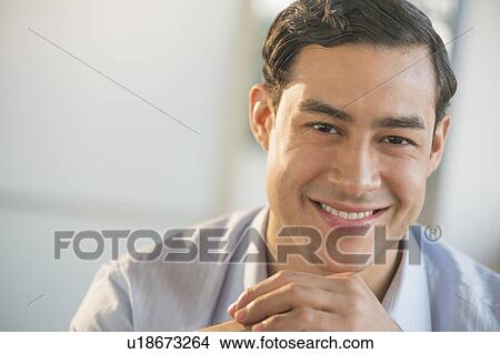 Picture - Portrait of smiling male executive in office. Fotosearch