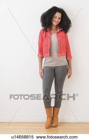 Portrait of smiling mid adult woman standing against wall View Large Photo Image Stock Photography - Portrait of smiling mid adult woman standing against wall. Fotosearch