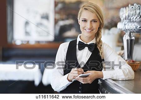 Stock Image - Portrait of smiling waitress. Fotosearch