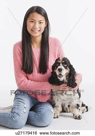 Stock Photograph - Portrait of teenage girl ( 16-17 years) with dog. Fotosearch