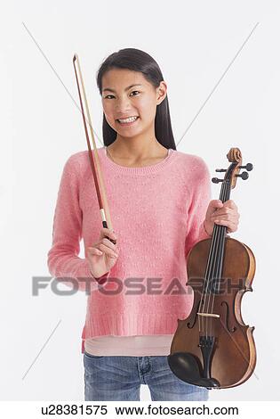 Stock Photography - Portrait of teenage girl ( 16-17 years) holding violin. Fotosearch