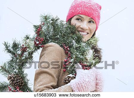 Portrait of woman in winter clothes carrying wreath View Large Photo Image Stock Image - Portrait of woman in winter clothes carrying wreath. Fotosearch