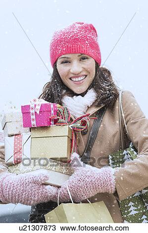 Portrait of woman in winter clothes carrying presents View Large Photo Image Stock Image - Portrait of woman in winter clothes carrying presents. Fotosearch