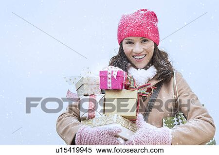 Portrait of woman in winter clothes carrying presents View Large Photo Image Stock Photography - Portrait of woman in winter clothes carrying presents. Fotosearch