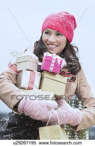 Portrait of woman in winter clothes carrying presents View Large Photo Image Stock Photography - Portrait of woman in winter clothes carrying presents. Fotosearch