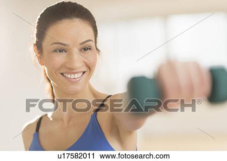 Portrait of woman lifting weights View Large Photo Image Stock Image - Portrait of woman lifting weights. Fotosearch