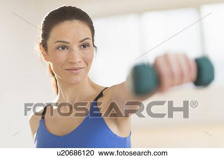Portrait of woman lifting weights View Large Photo Image Stock Image - Portrait of woman lifting weights. Fotosearch
