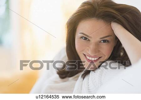 Portrait of woman sitting on sofa View Large Photo Image Stock Photography - Portrait of woman sitting on sofa. Fotosearch