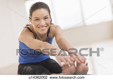 Portrait of woman stretching in gym View Large Photo Image Stock Image - Portrait of woman stretching in gym. Fotosearch