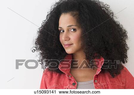 Stock Image - Portrait of woman with afro hair. Fotosearch