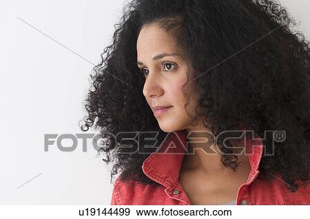 Stock Photo - Portrait of woman with afro hair. Fotosearch