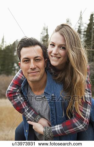 Stock Image - Portrait of young couple in non-urban scene. Fotosearch