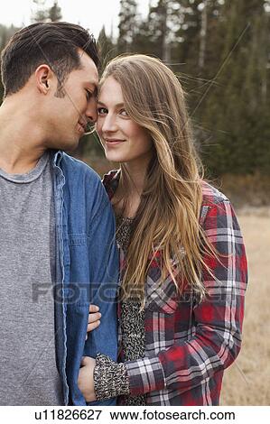 Stock Photo - Portrait of young couple in non-urban scene. Fotosearch