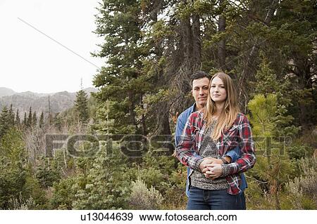 Stock Photo - Portrait of young couple in non-urban scene. Fotosearch