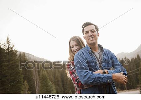 Stock Photograph - Portrait of young couple in non-urban scene. Fotosearch