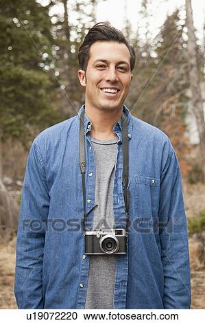 Portrait of young man with old fashioned camera in non-urban scene View Large Photo Image Stock Image - Portrait of young man with old fashioned camera in non-urban scene. Fotosearch