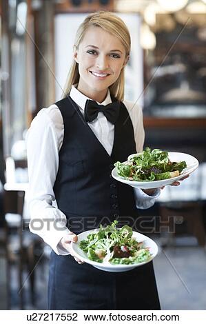 Portrait of young waitress holding plates with salad View Large Photo Image Stock Image - Portrait of young waitress holding plates with salad. Fotosearch