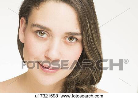 Portrait of young woman, studio shot View Large Photo Image Stock Photo - Portrait of young woman, studio shot. Fotosearch