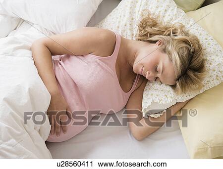 Pregnant woman asleep in bed View Large Photo Image Stock Image - Pregnant woman asleep in bed. Fotosearch
