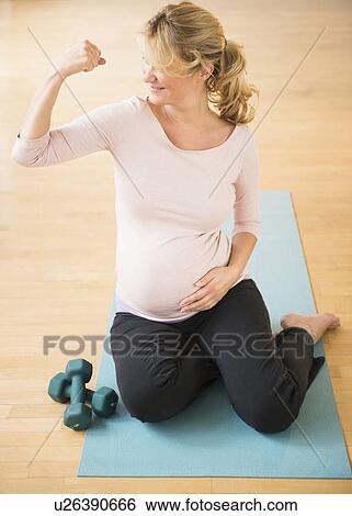 Pregnant woman exercising on mat View Large Photo Image Stock Photograph - Pregnant woman exercising on mat. Fotosearch