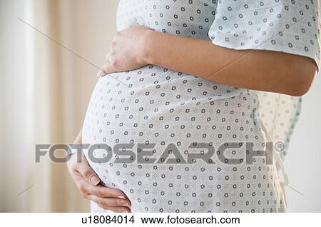 Pregnant woman in hospital outfit View Large Photo Image Picture - Pregnant woman in hospital outfit. Fotosearch