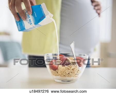Pregnant woman preparing breakfast View Large Photo Image Stock Photograph - Pregnant woman preparing breakfast. Fotosearch