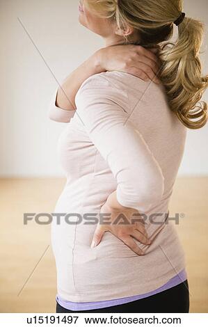 Pregnant woman suffering from backache View Large Photo Image Stock Photo - Pregnant woman suffering from backache. Fotosearch