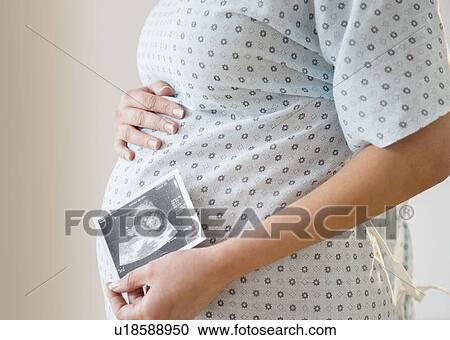 Pregnant woman with ultrasound scan of fetus View Large Photo Image Stock Image - Pregnant woman with ultrasound scan of fetus. Fotosearch