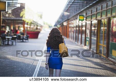 Stock Photography - Rear view of walking elegant woman. Fotosearch