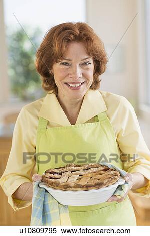 Stock Photography - Senior woman baking pie. Fotosearch