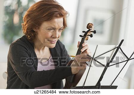 Picture - Senior woman composing music. Fotosearch
