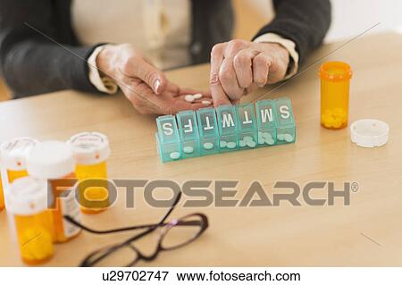 Senior woman dozing pills View Large Photo Image Stock Photo - Senior woman dozing pills. Fotosearch