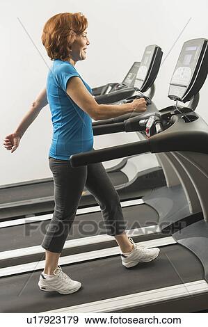 Stock Photo - Senior woman on treadmill. Fotosearch