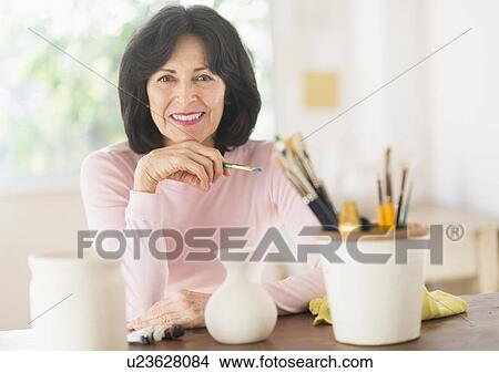 Senior woman painting handmade pottery View Large Photo Image Picture - Senior woman painting handmade pottery. Fotosearch