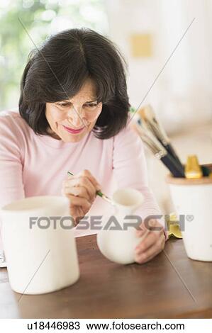 Senior woman painting handmade pottery View Large Photo Image Stock Image - Senior woman painting handmade pottery. Fotosearch