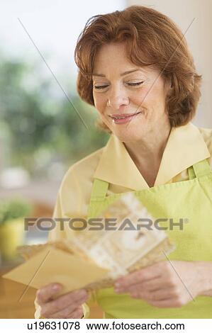 Senior woman reading greeting card View Large Photo Image Stock Photo - Senior woman reading greeting card. Fotosearch