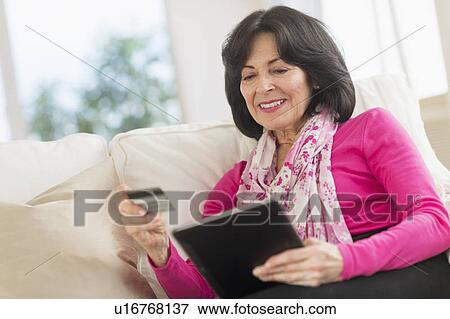 Senior woman with digital tablet and credit card View Large Photo Image Stock Photo - Senior woman with digital tablet and credit card. Fotosearch