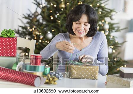Senior woman wrapping christmas gifts View Large Photo Image Stock Image - Senior woman wrapping christmas gifts. Fotosearch