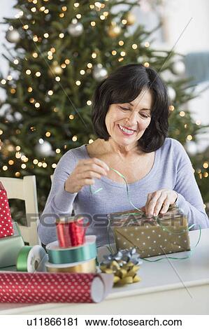 Senior woman wrapping christmas gifts View Large Photo Image Stock Image - Senior woman wrapping christmas gifts. Fotosearch