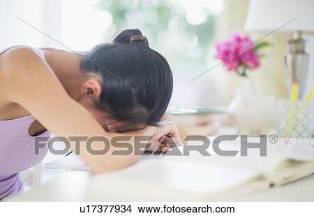 Side view of teenage girl ( 16-17 years ) with her head on table View Large Photo Image Picture - Side view of teenage girl ( 16-17 years ) with her head on table. Fotosearch