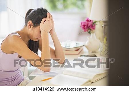 Stock Photograph - Side view of teenage girl (16-17 years) studding. Fotosearch