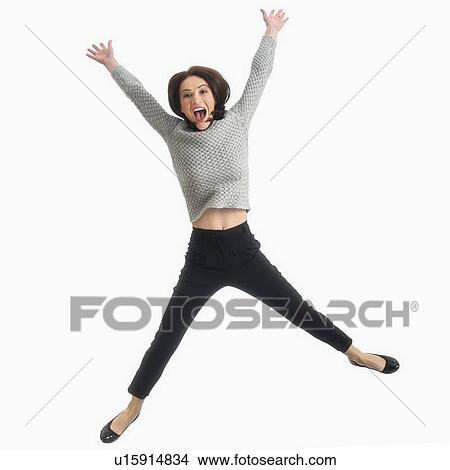 Studio portrait of mid adult woman jumping View Large Photo Image Picture - Studio portrait of mid adult woman jumping. Fotosearch