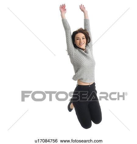 Studio portrait of mid adult woman jumping View Large Photo Image Stock Photograph - Studio portrait of mid adult woman jumping. Fotosearch