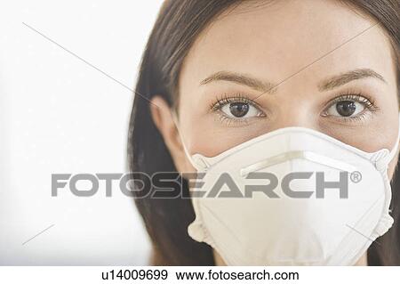 Studio portrait of woman wearing flu mask View Large Photo Image Stock Photo - Studio portrait of woman wearing flu mask. Fotosearch
