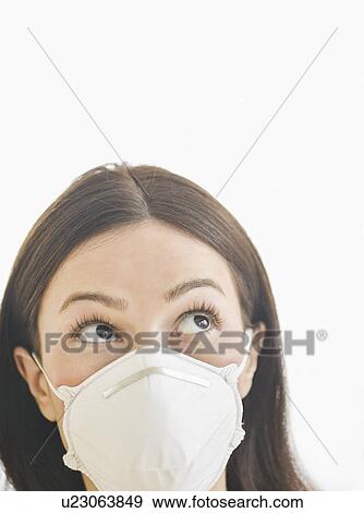 Studio portrait of woman wearing flu mask View Large Photo Image Stock Photo - Studio portrait of woman wearing flu mask. Fotosearch