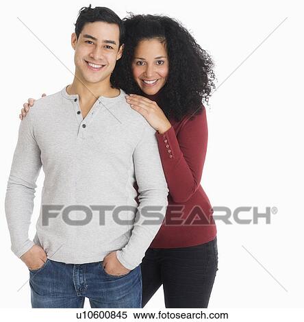 Stock Photography - Studio portrait of young couple. Fotosearch